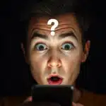Surprised person reacting to something unexpected on screen with a curiosity expression.