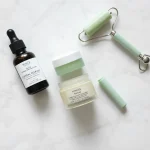 Skincare flat lay with serum bottles and beauty roller
