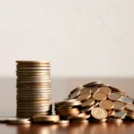 Stack of neatly growing coins beside a messy pile, representing how inconsistency ruins plans by stopping long-term growth.
