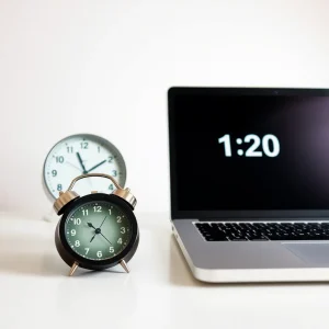 3121125 Alarm clock and laptop showing countdown timer to illustrate urgency and limited time
