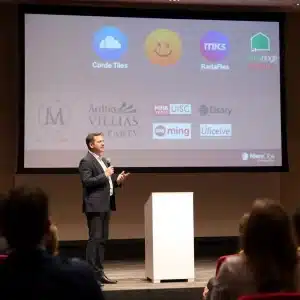 Professional speaker showing expertise and media coverage to establish authority in a presentation setting.
