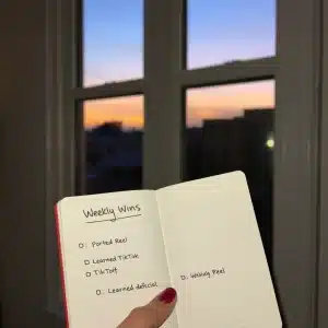 4011225 Evening reflection of a new marketer tracking weekly wins and growth.