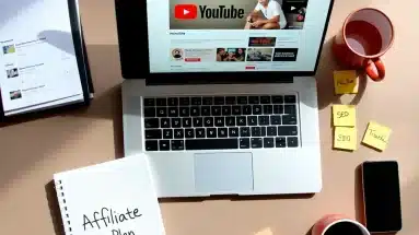 YouTube affiliate marketing workspace with laptop, notes, and coffee mug