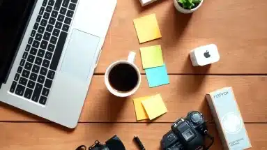 Creative desk setup with tools for writing product reviews and a laptop open to a review draft.