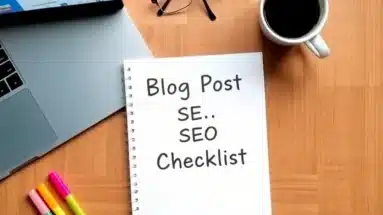 Flat lay of blog post SEO checklist on desk with analytics tools