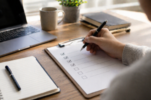 Hand checking off a content review checklist before publishing a post.