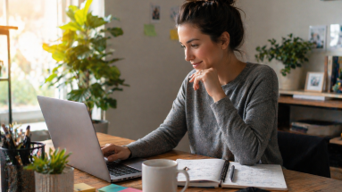 Content creator returning to social media after a break, planning a fresh start at a desk with a laptop and notebook.