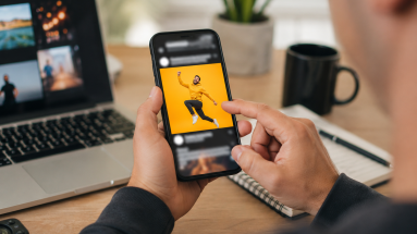 Person noticing a standout social media post on a smartphone in a modern workspace, representing scroll-stopping content hooks.
