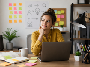 Beginner marketer using copywriting frameworks to plan better ads at a laptop.